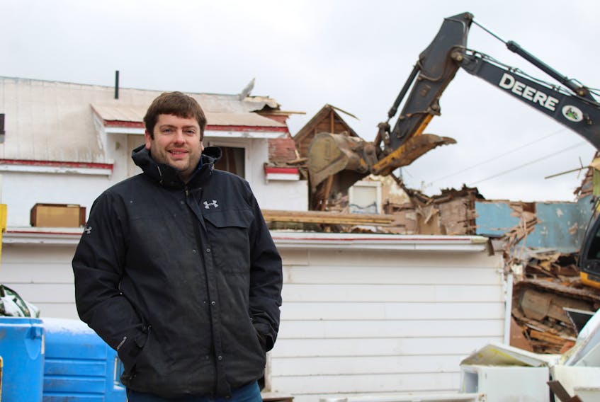 Mike Frizzell, owner of Mike's Queen Street Meat Market, stands in front of the old building that housed his Charlottetown business as it was being demolished Nov. 13.