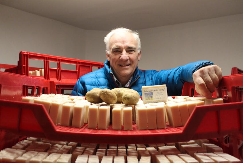 Pieter Ijsselstein surrounds himself with the star product of his company, Island Potato Soap Company. One of the main ingredients of his product is P.E.I. potato juice. Daniel Brown/The Guardian.
