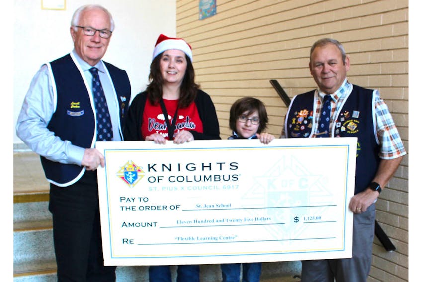 Lowell Croken, left, and Dan Miller, right, St. Pius X Knights of Columbus Council No. 6917, present a cheque for $1,125 to Maureen Cassivi, principal of St. Jean School in Charlottetown and student Kian Savoie. On Nov. 19, the council held a pancake breakfast and donated the proceeds to the school for its proposed new Flexible Learning Room. This room is designed to accommodate many of the students who are new immigrants from war-torn countries. These students require a program/room to practice calming strategies to assist in dealing with anxiety, behaviours and adjustments to a classroom environment. The proposed cost is $20,000.