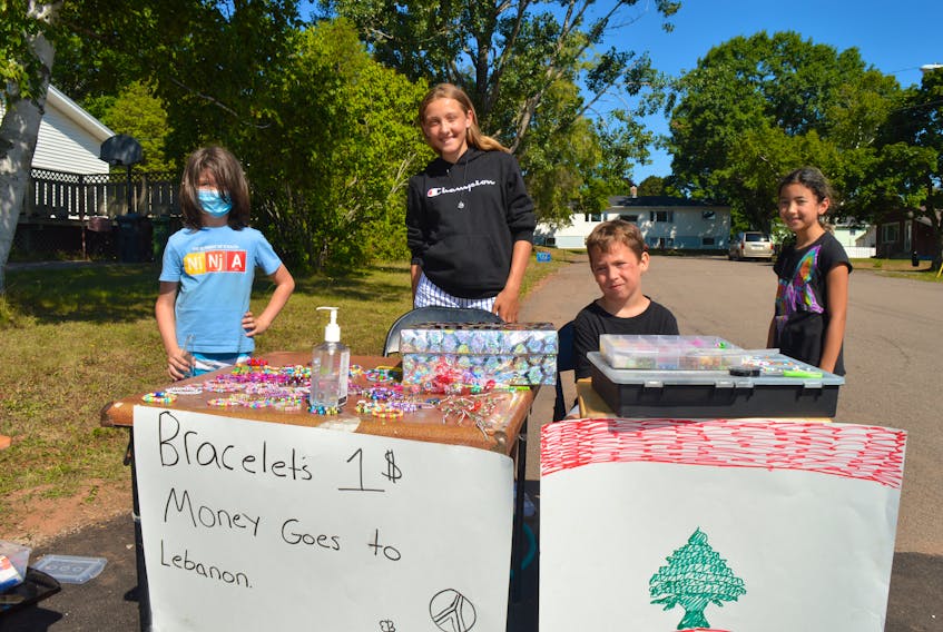 Rosa Coles, 13, second from left, got a group of friends together and decided to make bracelets and necklaces and sell them in an effort to aid relief efforts in Lebanon. From left, are Jake Gosson, Rosa, Clinton Dougan and Malaya Gallant. They have set up shop at the corner of Dennis Crescent and Parkview Drive in Charlottetown.