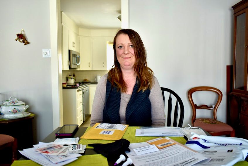 LeeAnne Murray sits at her kitchen table with the contents of a dried blood spot sample testing kit. Murray is one of 1,756 Islanders to receive a kit as part of the Canadian COVID-19 Antibody and Health Survey.