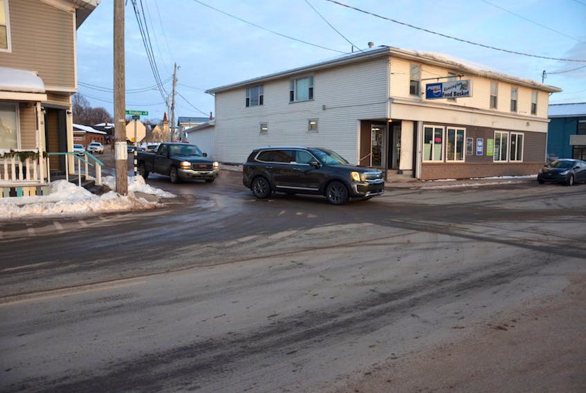 A vehicle carefully turns left onto Broadway Street North from Commercial Street in Kensington. The town council discussed possible changes to improve this intersection at its recent monthly meeting. This turn is increasingly difficult when the parking space in front of the Kensington Food Basket closest to the corner is occupied.