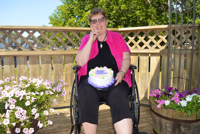 Marlene Bryenton holds a cake celebrating her next book, Jaya’s Magic Wheelchair, which is about her 11-year-old granddaughter. The Charlottetown resident, who is hoping to release the book on her 70th birthday in September, is currently recovering from hip surgery.