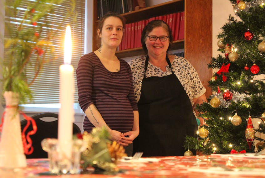 Santana Godin, left, and her foster mother, Anne Van Donkersgoed, prepare for an evening dinner at the Montague Bible Fellowship on Dec. 14. Godin is also volunteering at the sixth annual Three Rivers and area Christmas dinner on Dec. 25, which is always fun time, she said.