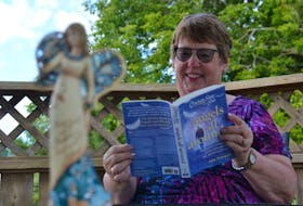 Marlene Bryenton reads a preview copy of Chicken Soup for the Soul: Angels All Around. It’ll be released on Aug. 27, and it’ll feature a short story that she wrote.