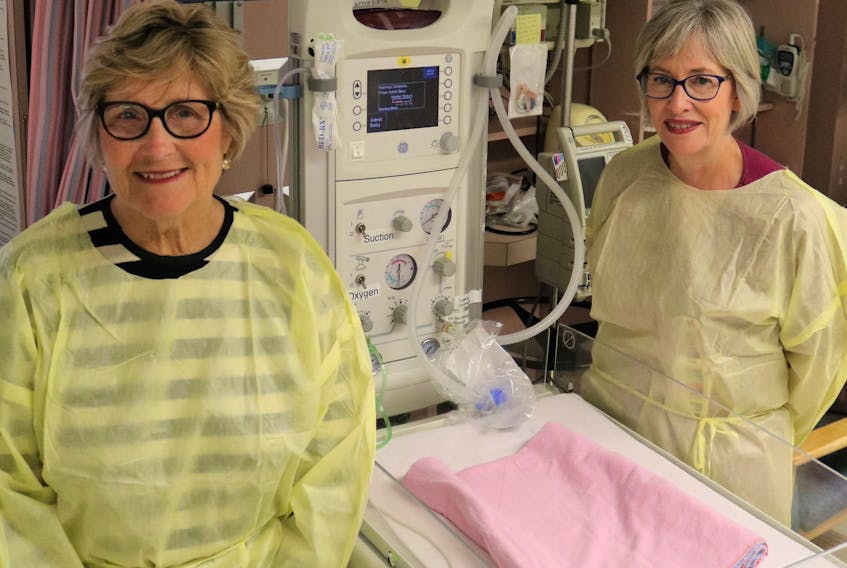 Wo-He-Lo Club President Heather Keith, left, and QEH Neonatal Clinical Lead Bonnie Fraser, RN, display the currently utilized baby warmer in the QEH NICU. The advanced replacement equipment, a Giraffe Omnibed, is a combination of an incubator and a warmer, providing an optimal neonatal environment for newborn patients, and will cost approximately $55,000. The Wo-He-Lo Sale begins Wednesday, Oct. 16 from 12-4 p.m., Thursday, Oct. 17 from 8 a.m. to 8 p.m. and Friday, Oct. 18 from 9 a.m. to 1 p.m. at the QEH. Submitted