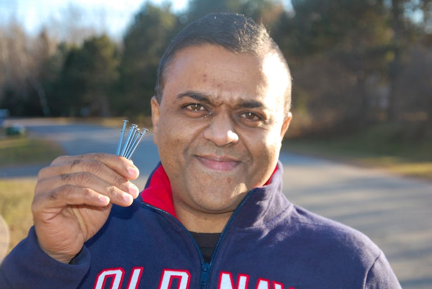 Ajay Punnapadam of Stratford makes a concerted effort to pick up nails and other sharp objects that could puncture tires when he walks along the shoulder of the highway for his daily stroll.