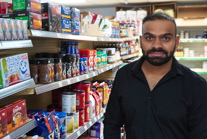 Krunal Patel, owner of Harvey's General Store in Crapaud, stands in one of the store's aisles on Dec. 16.