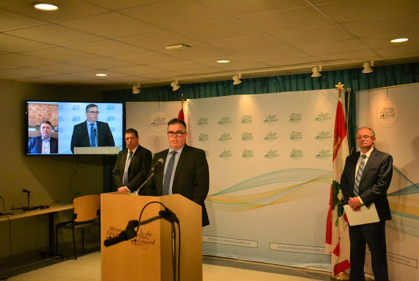 P.E.I. Ministers Matthew MacKay, Steven Myers and Ernie Hudson, along with Premier Dennis King via video link, address media on Tuesday during a briefing on the COVID-19 pandemic. All Ministers remained seemingly at a safe social distance from one another.
Stu Neatby/THE GUARDIAN