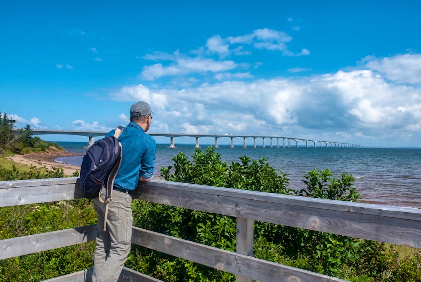 A man at Cape Jourimain, N.B., looks at the Confederation Bridge span towards Prince Edward Island in this stock photo.