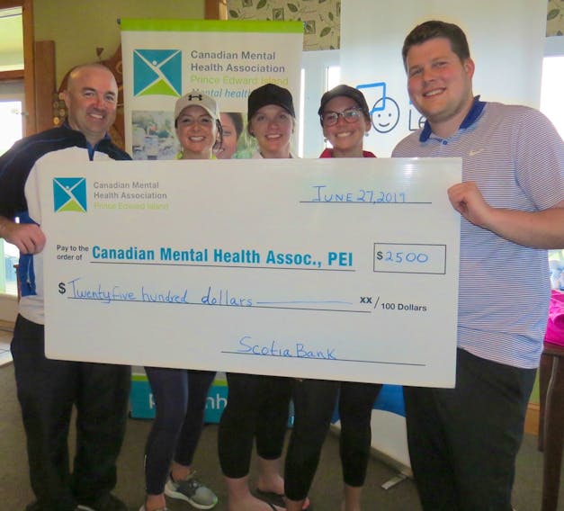 Chairman of the Golf for Life committee, Mark Smallwood, left, presents a cheque to the P.E.I. CMHA alongside Scotiabank employees Erica Bustard, Jessica Saunders, Ashley Gallant and Chris Hawkes the branch manager of the Scotiabank on Grafton Street.