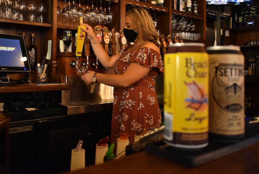 Emily Burt, assistant general manager at Gahan House, pours up a Beach Chair Lager, one of two P.E.I. Brewing Company beers which won awards at the 2020 Canadian Brewing Awards.