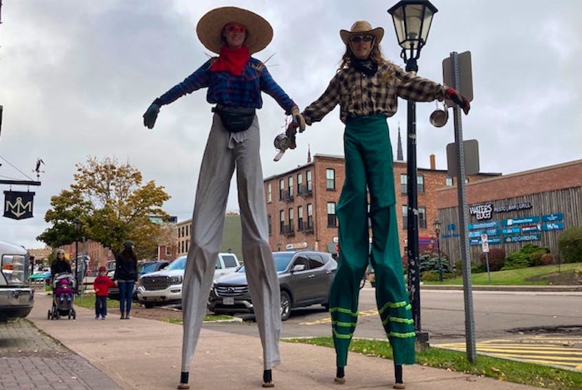 Zora and Fidel Wendt of Millvale, P.E.I., wander the streets of Charlottetown on stilts Saturday to promote the Scarecrows in the City Festival. They are members of the Island Stilt Alliance. A schedule of events for the festival, which ends Sunday, is available its Facebook page.