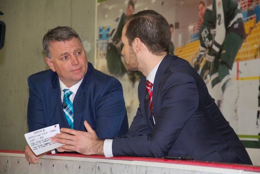 Premier Dennis King, left, listens to a question from Guardian reporter Stu Neatby during a segment of the year-end interview held in the players' bench at the MacLauchlan Arena.