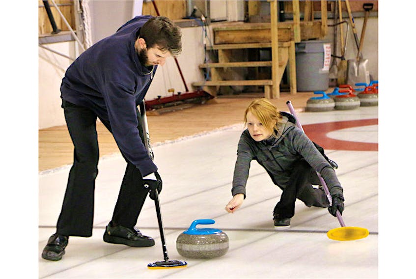 Lauren MacFadyen releases a shot while Alex MacFadyen sweeps the rock during play in the 2021 P.E.I. mixed doubles curling championship at the Cornwall Curling Club this past weekend. The brother-and-sister team from the Silver Fox in Summerside went 7-1 (won-lost) on their way to capturing the provincial title.