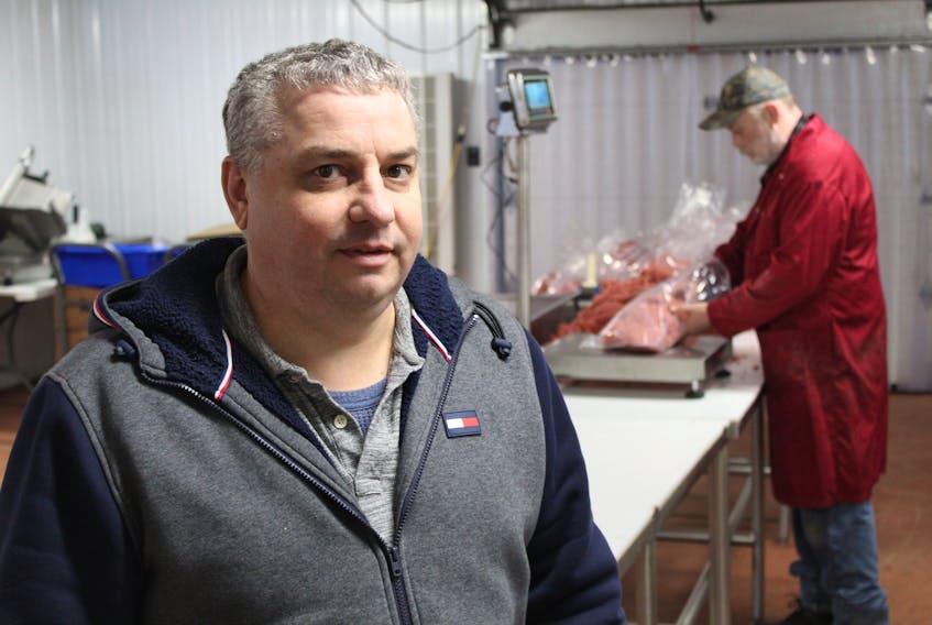 Dwayne MacQuarrie, left, and MacQuarrie Meats employee Gerard Costello are processing meat out of a secondary shop in Winsloe following the fire that claimed the businesses slaughterhouse on Feb. 1.