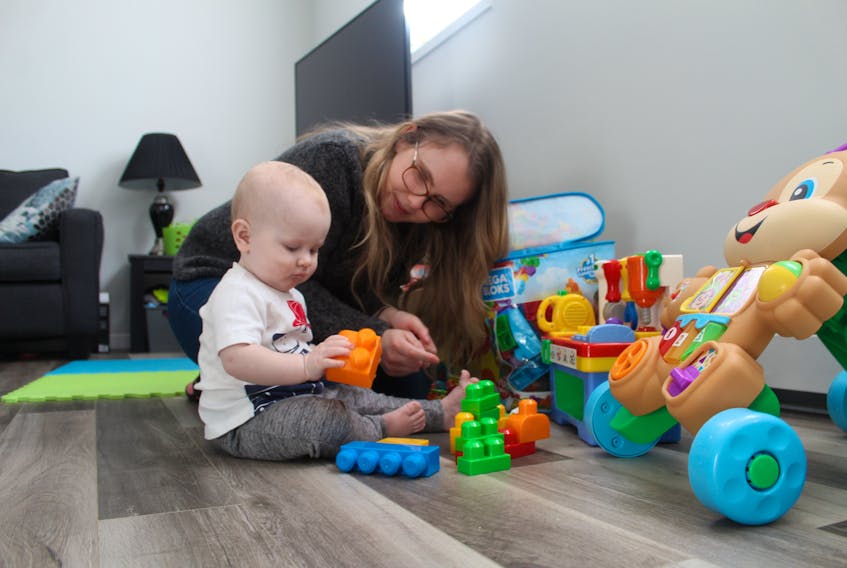 Megan Crozier plays with her 11-month-old son Chance at their home in Charlottetown. Chance has been on a waiting list for childcare since he was two months old.