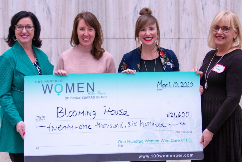 Kathleen Casey, left, and Aileen Matters, right, present Blooming House co-founders Brynn Devine and  Liz Corney, second right, with a cheque from money raised at a recent meeting of 100 Women Who Care, P.E.I. chapter.