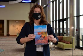 Brenda Gallant, Tourism P.E.I.'s director of marketing, holds a copy of the 2021 visitor's guide on Thursday at the unveiling of the province's annual tourism marketing campaign in Charlottetown.