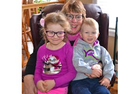 Marlene Bryenton shares a special moment with Anna Bryenton (left) and James Bryenton. Her grandchildren are stars in her new book, Anna’s Pink and Purple Glasses.