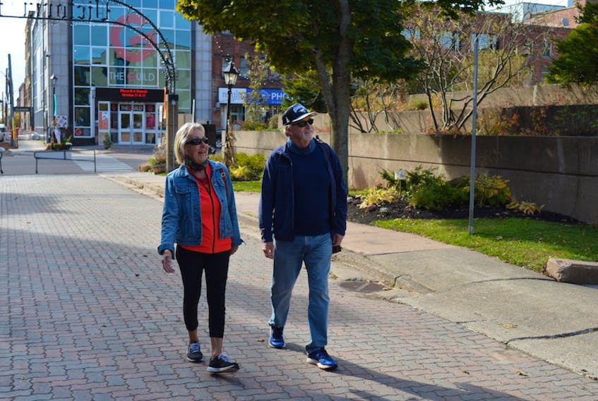 Gabriele Bentley and her husband, Alan, enjoy a walk on Victoria Row on Monday. The Bentleys said they love the idea of making the surrounding area more pedestrian friendly.