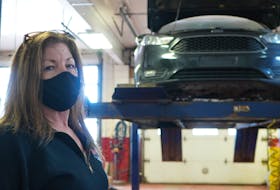 Lisa MacIntyre, owner of Her Man's Shop, stands in her auto shop in Morell on Jan. 21