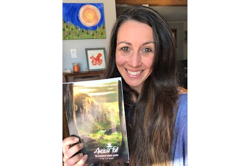 Jaime Lee Mann holds a copy of her latest book, Ancient Fall: The Legend of Rhyme Series.  The book was launched this past September. It’s available at the Book Mark, Indigo, Coles and through Amazon.