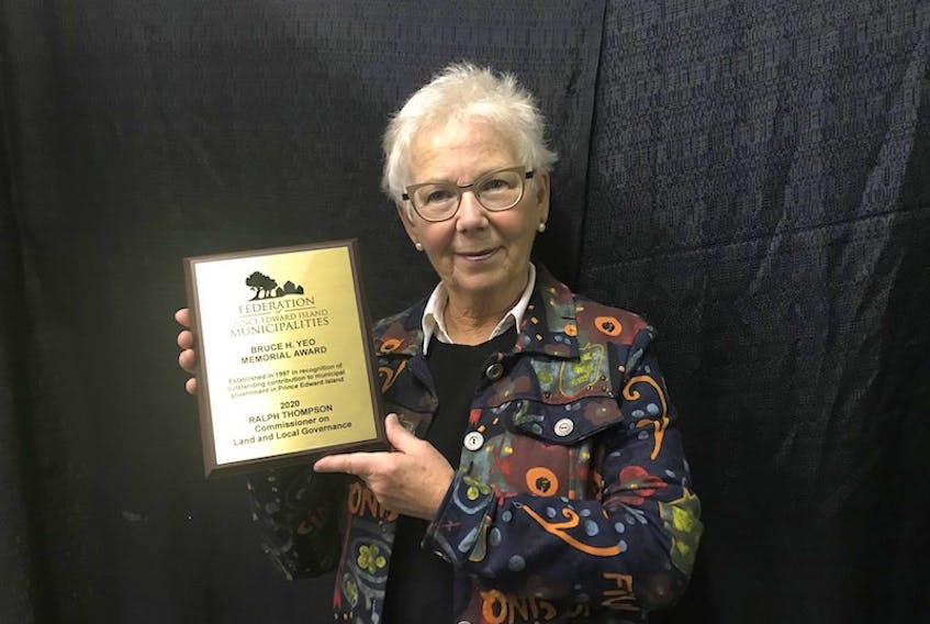 Karen Thompson accepts the Bruce H. Yeo Award on behalf of her late husband, Ralph Thompson, at the Federation of P.E.I. Municipalities’ annual meeting on Monday.  Photo special to The Guardian by Sally Cole.