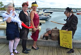 A rum runner (Michael Pendergast), a temperance supporter (Cathy Corrigan) and three flappers create a scene at Peakes Wharf in Charlottetown to promote Glenaladale Heritage Trust’s Rum Running Festival. From left are Terry Howatt, Mary Bradley, Cheryl Dalziel and Cathy Corrigan. The festival runs Sept. 27-28 on and near the historical property on Tracadie Bay.