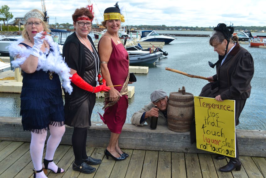 A rum runner (Michael Pendergast), a temperance supporter (Cathy Corrigan) and three flappers create a scene at Peakes Wharf in Charlottetown to promote Glenaladale Heritage Trust’s Rum Running Festival. From left are Terry Howatt, Mary Bradley, Cheryl Dalziel and Cathy Corrigan. The festival runs Sept. 27-28 on and near the historical property on Tracadie Bay.