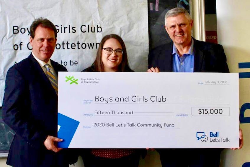 From left, James Aylward, health and wellness minister, Callen Cudmore, program director of the Boys and Girls Club, and Paul Montgomery, accounts manager at Bell hold a giant cheque showing the donation from Bell as part of their Let’s Talk Community Fund. The donation was announced at an event at the Boys and Girls Club in Charlottetown on Jan. 21.