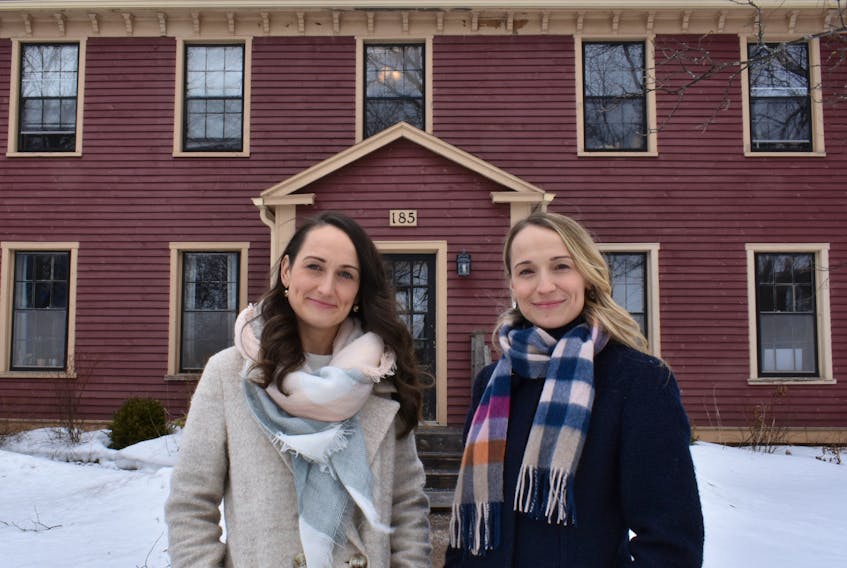 Melody McInnis and her sister, Krista Stevenson stand in front of the seven-unit long-term rental property Stevenson and her husband own at 185 King St. in Charlottetown. McInnis also owns a six-unit rental property in downtown Charlottetown with her husband. - Michael Robar
