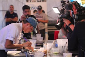 Chef Nick Chindamo puts the final touches on his dish, while under the pressure of cameras and a live audience at the P.E.I. International Shellfish Festival in Charlottetown on Sept. 22. - Daniel Brown