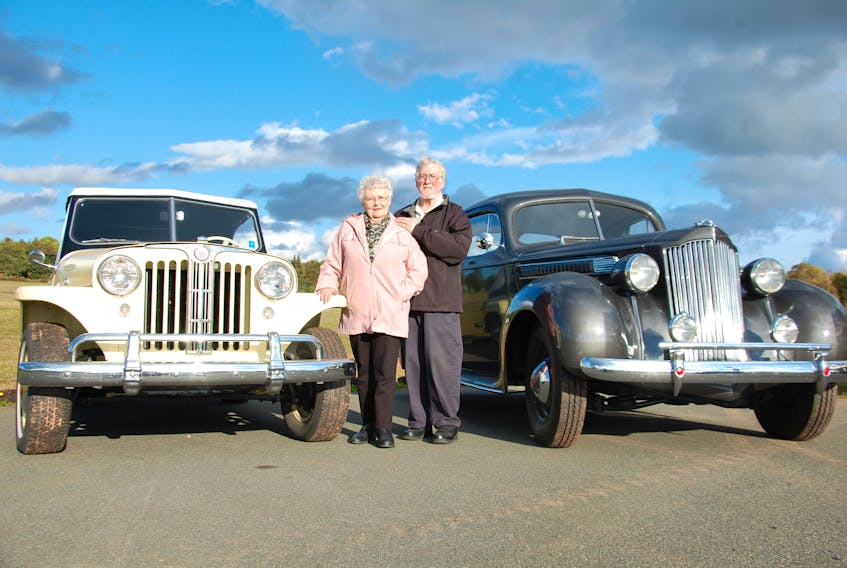 Doug and Roberta Parkman pose with a 1949 Willis Jeepster, left, and a 1939 Packard Six, which were both restored by Doug. The couple recently received the Hobbyist of the Year award from the National Association of Automobiles Club of Canada.
