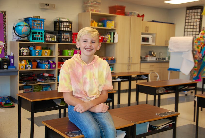 Connor Fitzpatrick, a Grade 6 student at Stratford Elementary, proudly displays his spacious classroom. Connor, like other students and the school's teachers, welcome a large addition that includes 14 classrooms, an auxiliary gym and breakout rooms.