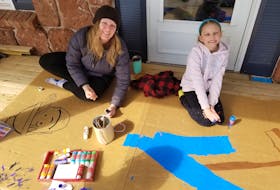 Kait Quadri and her seven-year-old daughter Aria painting the giant Waldo on March 19. They’ve started hiding him in their yard for neighbours to find when out for a walk or drive.