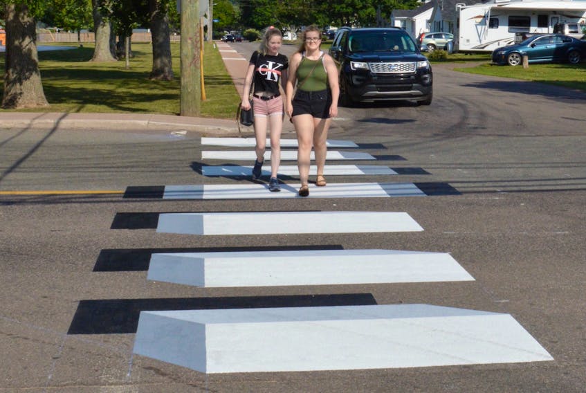 Tori Buell, left, and Shania Ellis use the new 3D crosswalk on Central Street in Summerside on July 20.
