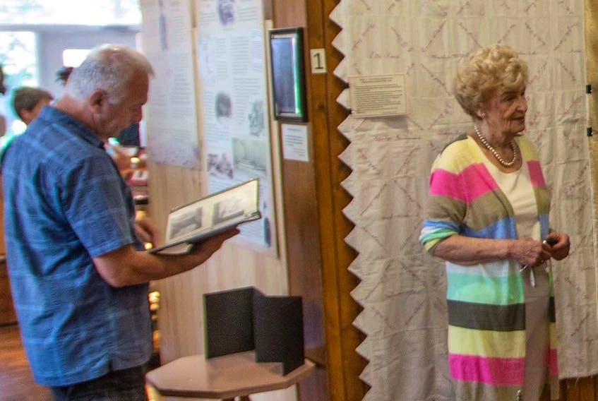 Visitors view quilts on the opening day of the Signature Quilt exhibit at the Bedeque Area Historical Museum. A special free day is being held at the museum Aug. 25. Don Jardine photo.