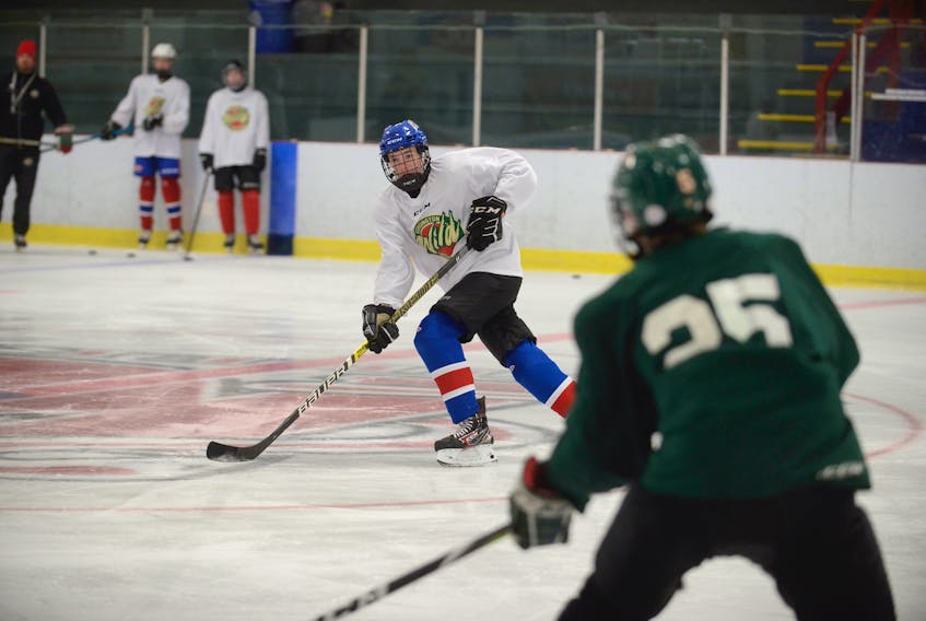 Brett MacAusland prepares to take a pass during the Kensington Monaghan Farms Wild practice Wednesday at the Credit Union Centre in Kensington.