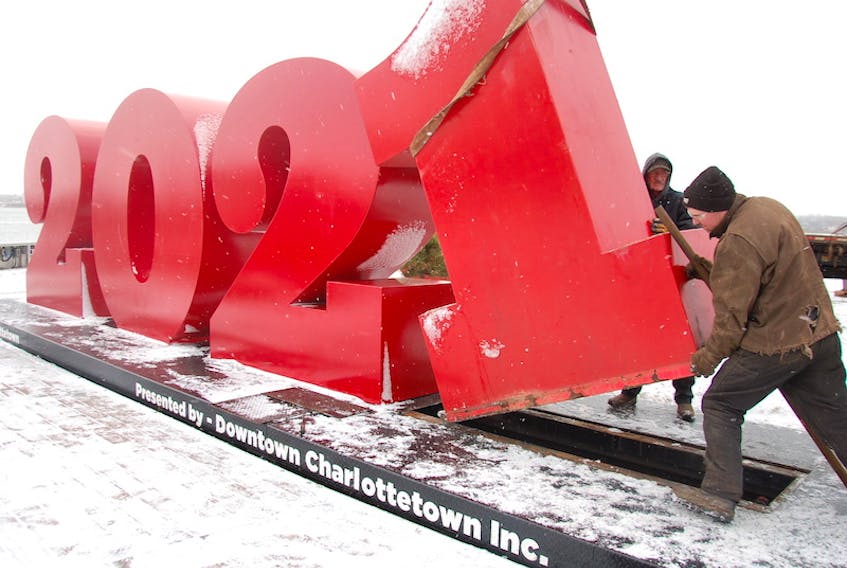 Chris Kenny, right, and Don O'Brien, both of Weld Tech, replace the number zero with the number one on the large red numbers by the water at the end of Queen Street in Charlottetown. Understandably, Downtown Charlottetown Inc. was ready to say goodbye to the pandemic-plagued 2020 a bit early Wednesday and usher in 2021.
