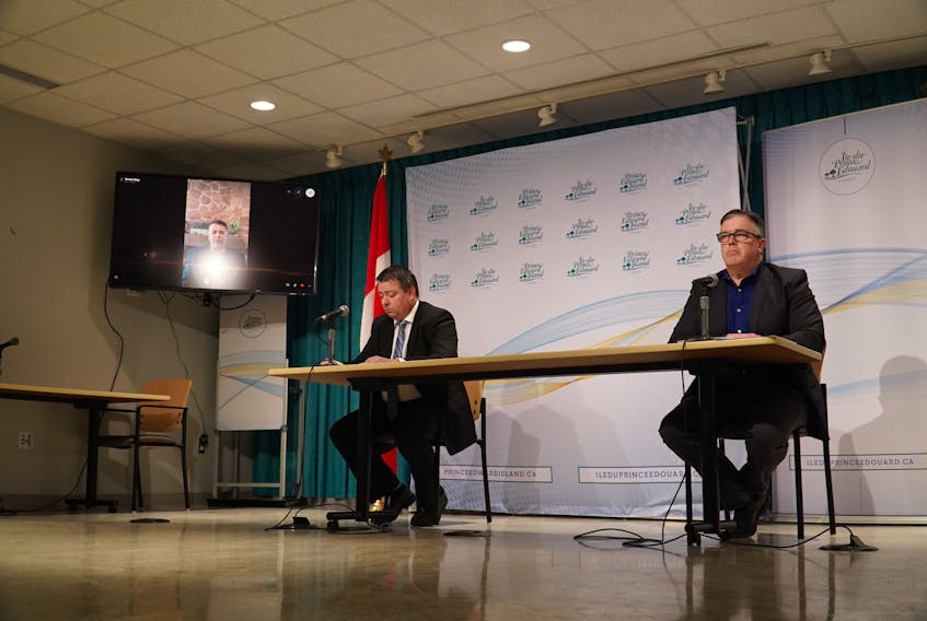 Matthew MacKay, Minister of Economic Growth and Tourism and Steven Myers, Minister of Transportation, Infrastructure and Energy, speak during a media briefing on Tuesday, March 24.