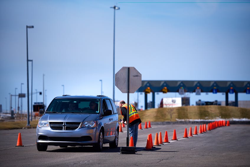 Cars wait in line at the COVID-19 checkpoint shortly after it was set up at the Confederation Bridge in Borden-Carleton earlier this week. All visitors to P.E.I. who are not considered essential workers are being stopped and screened for symptoms as they arrive in the province. Dr. Heather Morrison, chief public health officer for P.E.I., reminded Islanders Friday that anyone travelling across the Confederation Bridge should be doing so only out of necessity. She said examples of necessary travel include medical appointments, compassionate travel and truckers and other travellers carrying goods and services to P.E.I. For more from Morrison's briefing Friday, see A3.