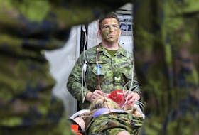 A reservist with the 33 Field Ambulance practices medical skills on an acting soldier during a training simulation at the Queen Charlotte Armoury in Charlottetown on Nov. 24. - Daniel Brown