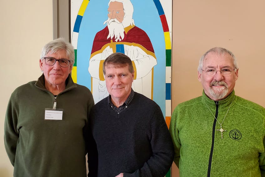 Gary MacDougall, second left, is greeted by Tom Garland, left, Charlottetown Area Christian Council (CACC) president, left, and Rev. Scott MacIsaac, spiritual leader at the CACC monthly meeting held at St. Peters Cathedral on Tuesday. MacDougall, a P.E.I. author and former managing editor of The Guardian, was guest speaker. His talk, What Puzzles Me about Religion and Society, was followed by a question and answer session and a discussion.