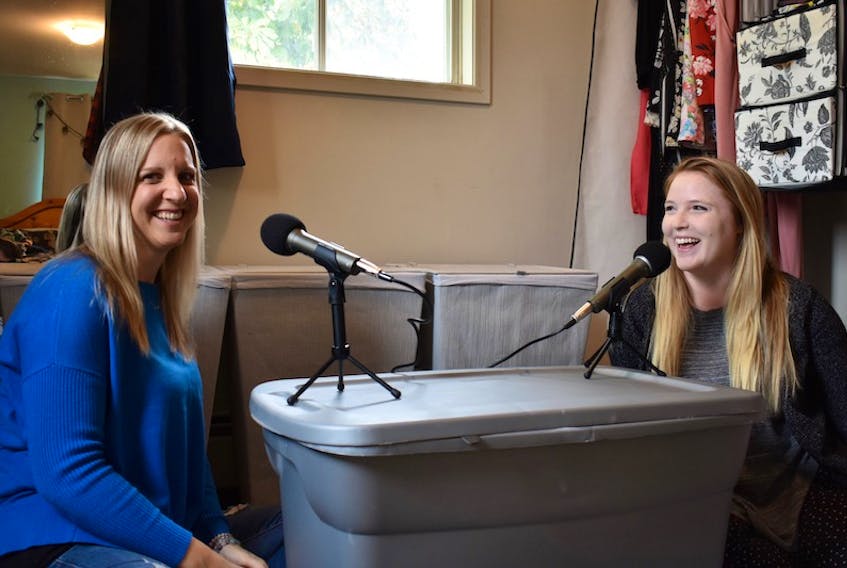 Julie Ann Gauthier, left, and Stephanie Perrault-Bittner laugh as they talk about recording their new podcast, Thriving Tides, in Perrault-Bittner's closet. Using this makeshift set-up, the pair has recorded 10 episodes of the podcast, which focuses on entrepreneurs and mental health