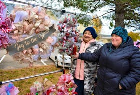 Susan and her daughter Lisa Ouellette show their handmade Christmas wreaths created with ribbons, bows and festive ornaments. “I make all-occasion wreaths – from Halloween, summer to winter themes,” said Susan Ouellette, a retired registered nurse. “I started making wreaths two years ago because I wanted one for myself, and it grew from there.”