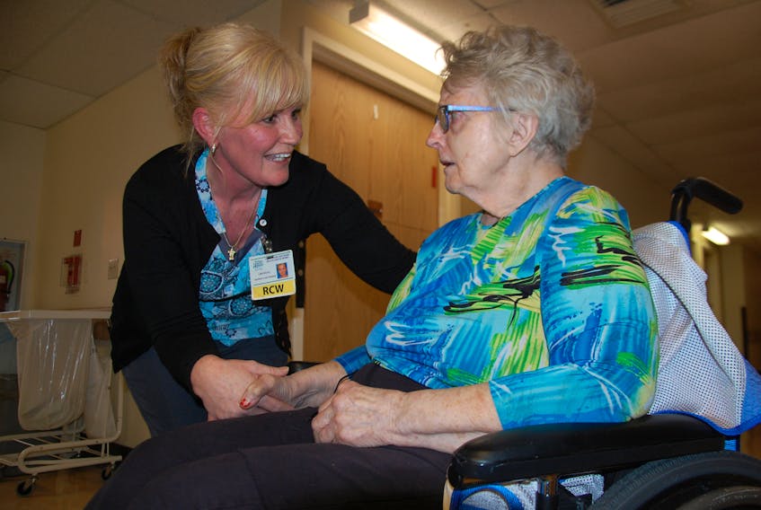 Beach Grove Home resident care worker Crystal Dumville of Brackley Beach chats with resident Rosalind McVicar. Dumville says she was overwhelmed to be named the co-recipient of the provincial Shelley L. Woods Excellence in Person Centred Care Award.