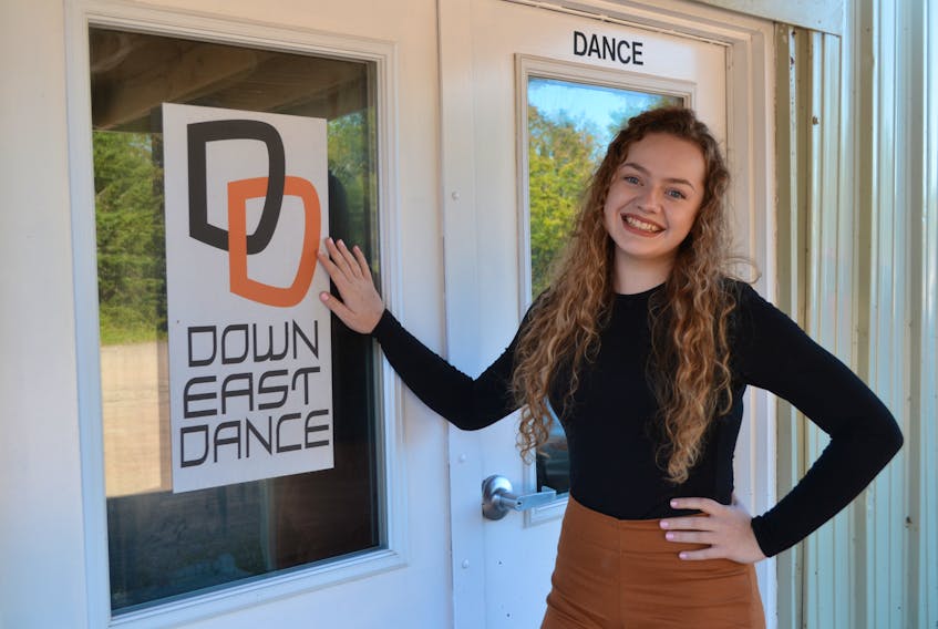 Charlotte Byrne stands at the door of Down East Dance in Montague. The 18-year-old is preparing for the Dance World Cup with help from her teacher, Marie Lavergne.