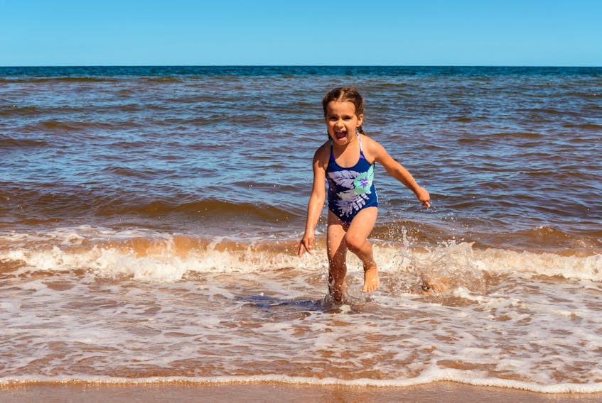 A little girl comes out of the water at Cavendish Beach in this undated photo. People are going to be heading to the water a lot this summer and, hopefully, physically distancing as a warmer than normal summer is in the forecast.