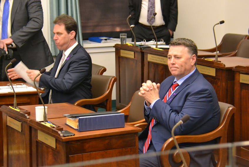 P.E.I. Premier Dennis King, right, sits in the legislature on Wednesday, Nov. 27, 2019, along with PC MLA James Aylward. Confusion reigned Wednesday over the procedure for three important confidence motions that ultimately ensured the King government would live at least one more day.